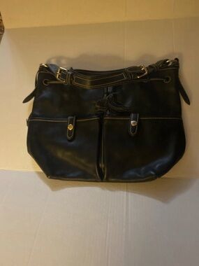 Dooney & Bourke Black Leather bag with drawstring , tassel and pockets.